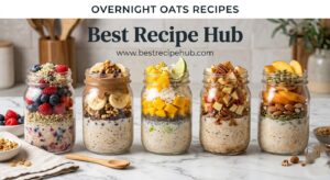 Five mason jars of different overnight oats recipes lined up on a marble kitchen counter, each topped with colorful fruits, nuts, and seeds for a healthy breakfast meal prep spread
