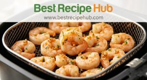 Perfectly cooked garlic butter shrimp in air fryer basket showing golden caramelized garlic bits and ideal C-shape curl indicating doneness