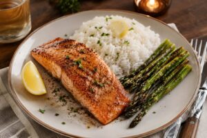 Plated steelhead trout dinner served with roasted asparagus and rice